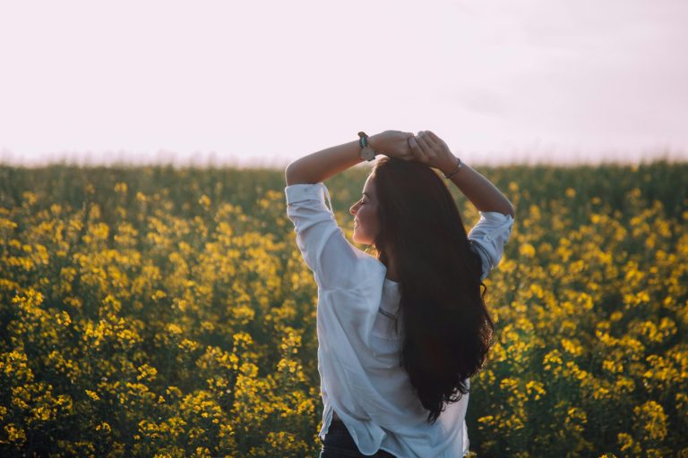 Woman in field of yellow flowers